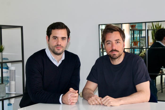 Seedtag co-CEOs Alberto Nieto and Jorge Poyatos stood at a desk in an office