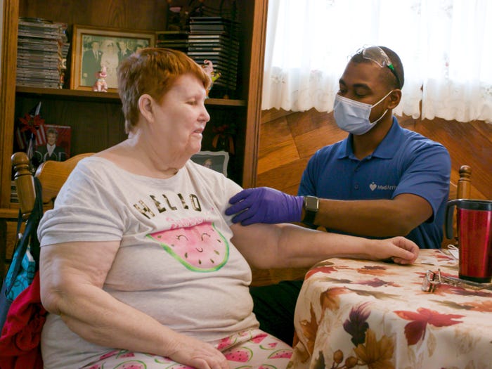A MedArrive professional meets with a patient in her home.