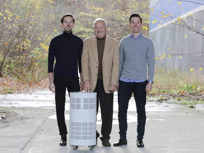 Christian Hendriksen, Henrik Hendriksen, and Frederik Hendriksen standing with Rensair filter