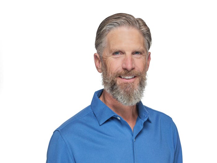 LucidLink cofounder and CEO Peter Thompson smiling in a blue shirt against a white background.
