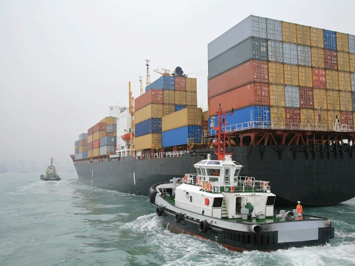 A cargo ship in a foggy Hong Kong harbor.