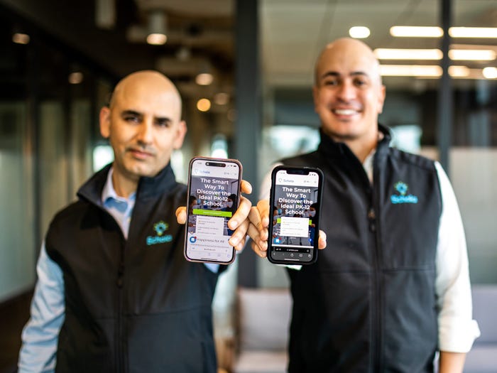 Headshot of Schola cofounders Jaime Martinez and Carlos Melendez holding phones with office background