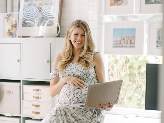 Hashtag Pay Me founder and ceo Cynthia Ruff poses with laptop while pregnant